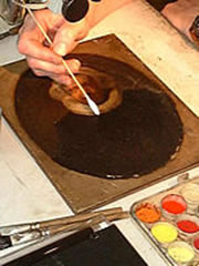Artist at work restoring a painting